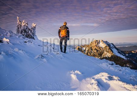 Man hiking in the mountains in winter