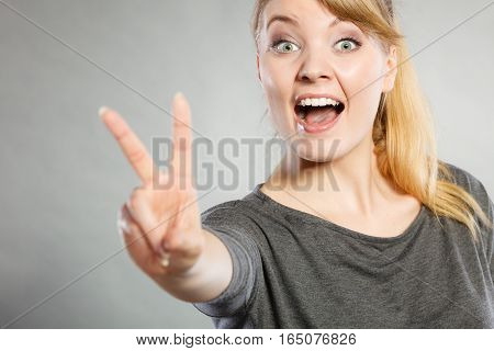 Cheerful Lady Makes V Gesture.