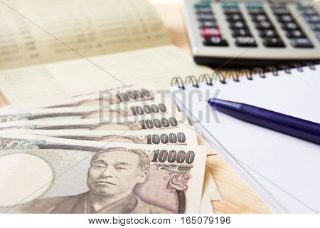 Saving account passbok japanese yen note book calculator and pen