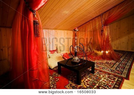 Narghilè su un tavolo nero in una bella sala in legno