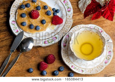 Cup Of Tea, Sauser, Rice Cracker With Peanut Butter, Berries And Honey On The Wooden Table