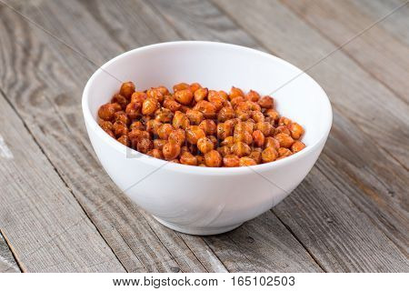 Roasted chickpeas with spices on rustic background