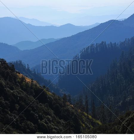 Landscape near Pokhara Nepal. View from Isharu. Layered mountain ranges covered by forest. Autumn fog.