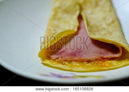 Ham and Salami Burrito on a white plate