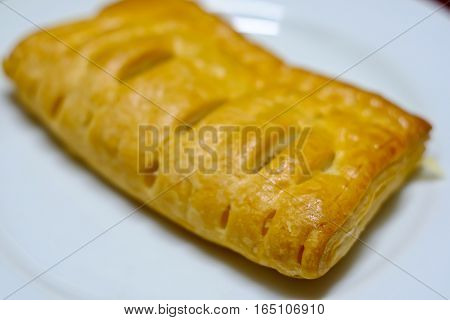 Pineapple pie on a white plate for breakfast.