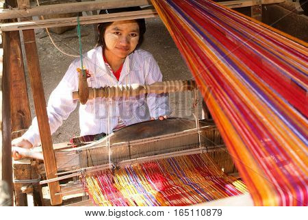 Minnanthu Myanmar - 24 January 2010: Woman weaving a craft at the village of Minnanthu on the archaeological site of Bagan on Myanmar