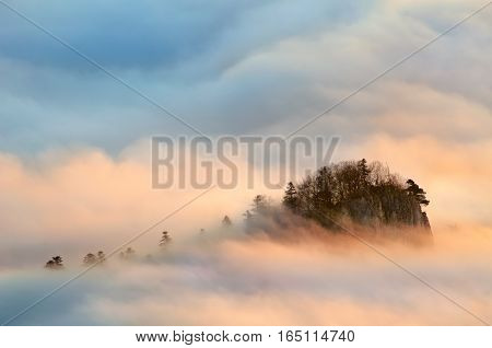 Sokolica summit in Pieniny mountains in foggy sunrise Poland