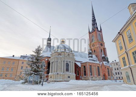 STOCKHOLM - JAN 08 2017: The Riddarholm church in Riddarholmen in central Stockholm a cold winter morning snow on the ground. January 08 2017 in Stockholm Sweden