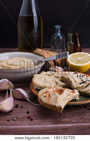 The hummus and ingredients in rustic style.