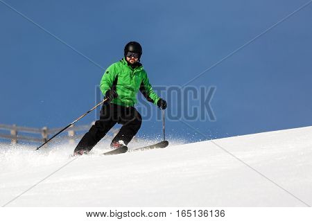 Male Skier Skiing On Ski Slope