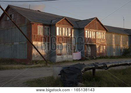 Misery and poor two-storeyed building in the evenong light