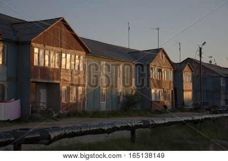 Misery and poor two-storeyed building in the evenong light