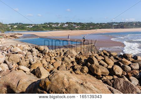 Southbroom beach women walking exploring tidal pool river lagoon ocean waves scenic landscape