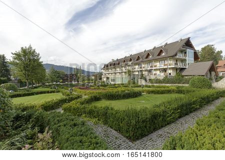 ZAKOPANE POLAND - SEPTEMBER 23 2016: Hotel Wersal that is located in a modern building with architecture reminiscent of the style of the region is surrounded by a beautiful garden providing peace