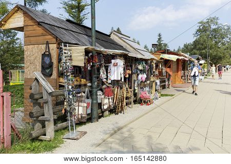ZAKOPANE POLAND - SEPTEMBER 12 2016: Stalls in which variety of souvenirs are put on sale. These stands are made of wood as provisional and are set along the sidewalk