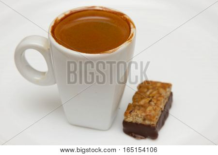 cup of hot espresso and candy on a white background, breakfast