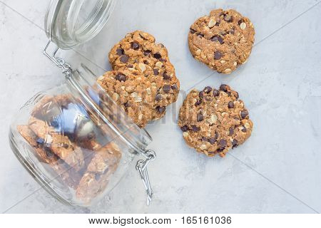 Flourless gluten free peanut butter oatmeal and chocolate chips cookies in glass jar top view horizontal