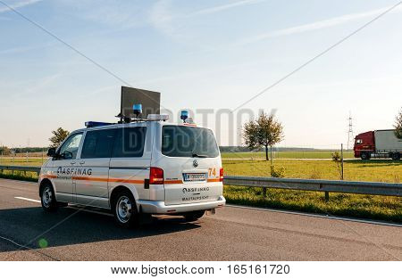 VIENNA AUSTRIA - SEP 30 2014: White Volkswagen maintenance security van from ASFiNAG tool road company. The ASFiNAG is an Austrian publicly owned corporation which plans finances builds maintains and collects tolls for the Austrian autobahns. The ASFiNAG
