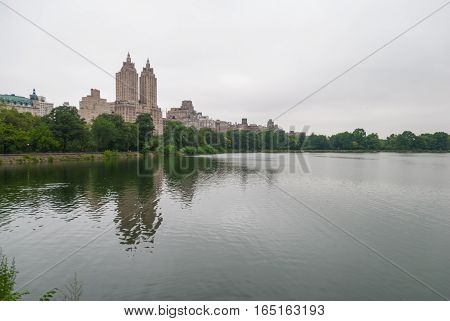 Twin towers reflecting in Central Park lake