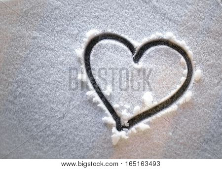 heart in the snow at night. winter