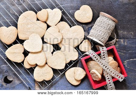 Shortbread cookies in the shape of hearts on wooden background St. Valentine