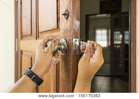 locksmith install the silver knob on old wood door by screwdriver - can use to display or montage on product