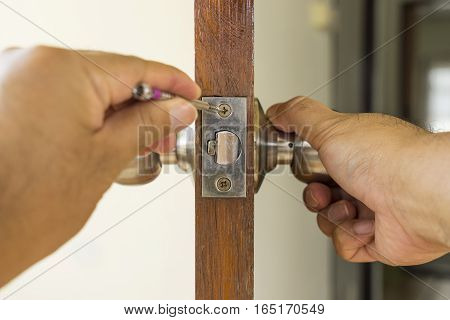 close-up locksmith repair on wood door - can use to display or montage on product
