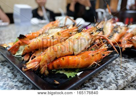 Burn shrim seafood on table. . .
