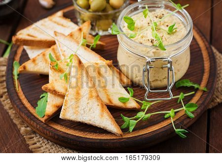 Pate Chicken - Rillette, Toast, Olives And Herbs On A Wooden Board