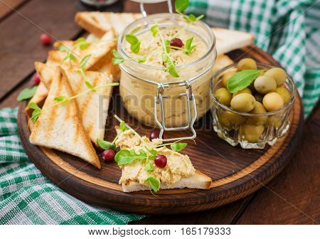 Pate Chicken - Rillette, Toast, Olives And Herbs On A Wooden Board