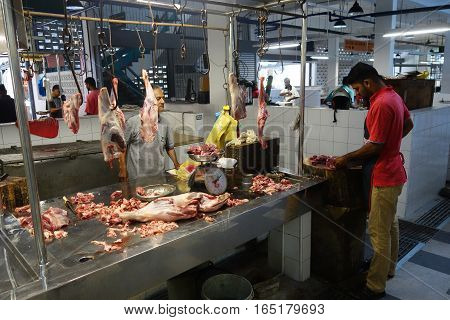 Unidentified Indian Butcher Sits At His Butcher Shop