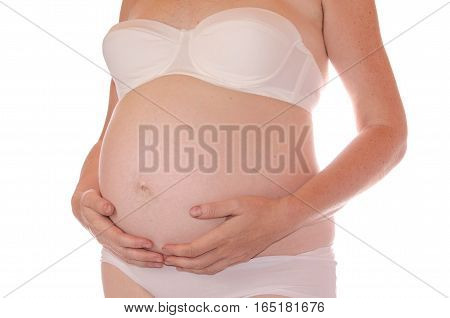 A pregnant woman with his hands groping her rounded belly