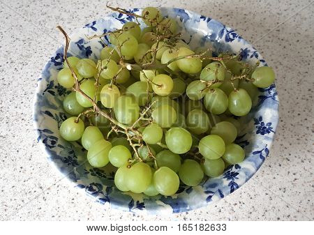 Fresh Green Grapes in a Blue Bowl on a Kitchen Countertop