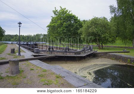 Vintage gateway on the Saimaa canal, cloud on a summer morning. Finland