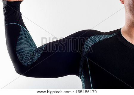 Man wearing black thermal base layer underwear on white background