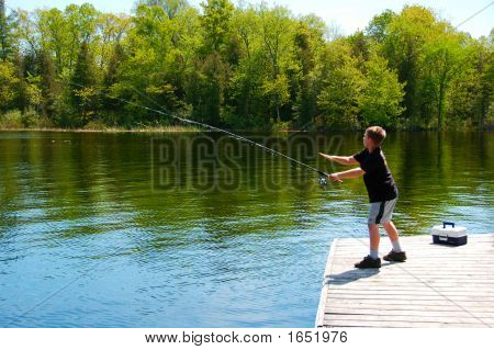 Boy Fishing On A Dock
