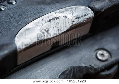 Scratched backslide plate and grind block on used aggressive inline skates for extreme skating.Professional specialized skate model to grind rail or ledge in street skatepark.Close upfocus on plates