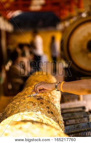 Gold Foil Leaf On Circle Stone In Buddhist Temple Thailand