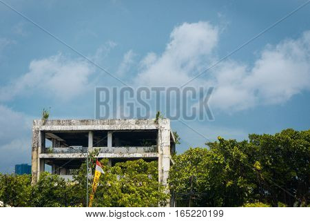 Abandoned office building with trees and cloudysky photo taken in Jakarta Indonesia java