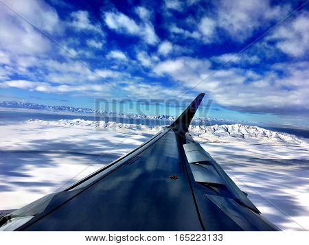 airplane wing flies over winter Salt Lake City
