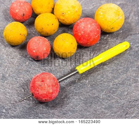 Carp Hook Boilies on black background .