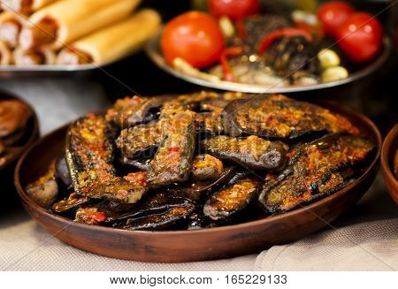 close-up of stuffed baked aubergines in pottery