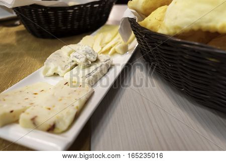 cheese plate with three different types and basket of crescentine