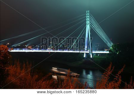 Russia Tyumen Region city Tyumen. Bridge lovers across the Tura River at night.