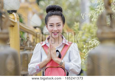 Beautiful Thai woman saluted with respectA beautiful young woman in a temple.