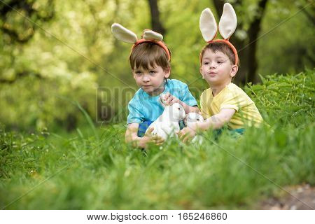 Two Little Kids Boys And Friends In Easter Bunny Ears During Tra