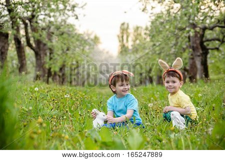 Two Little Kids Boys And Friends In Easter Bunny Ears During Tra