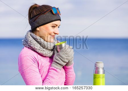 Fit Woman In Cold Day Warming Up Drink Tea