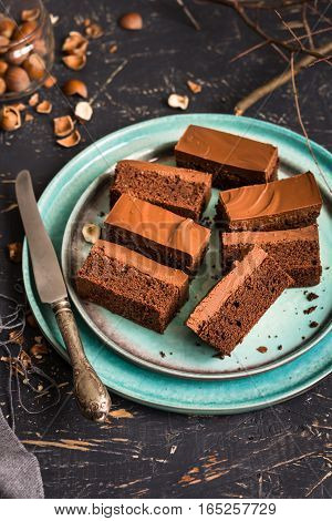 nutella, bars, dessert, sweet, brownie, cake, chocolate, cocoa, dark, frosting, ganache, rectangular, slices, blue, plate, dark, wood, board, coffee, hazelnuts, raw, whole,