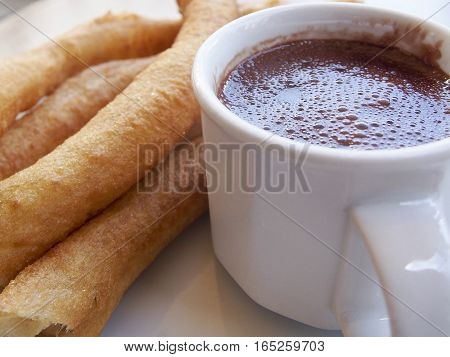 Churros con chocolate are a popular Spanish dessert. The fried churros are meant to be dipped in the rich hot chocolate.